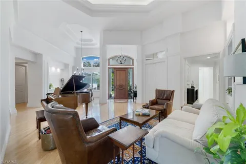 a living room with furniture and a chandelier