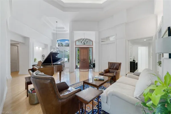 a living room with furniture and a chandelier