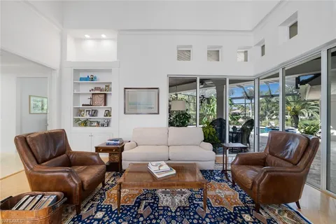 a living room with furniture ceiling fan and a rug