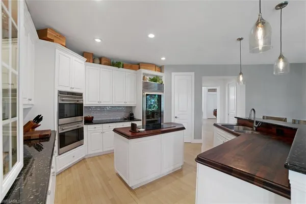 a kitchen with a stove a refrigerator and a sink