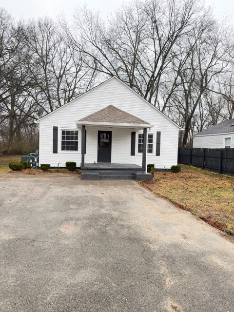 a front view of house with yard covered in snow