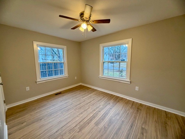 417 Laura Avenue Winchester, TN 37398 - Photo 11 of 18 a view of an empty room with a window and wooden floor