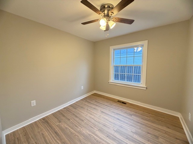 417 Laura Avenue Winchester, TN 37398 - Photo 12 of 18 wooden floor in an empty room with a window