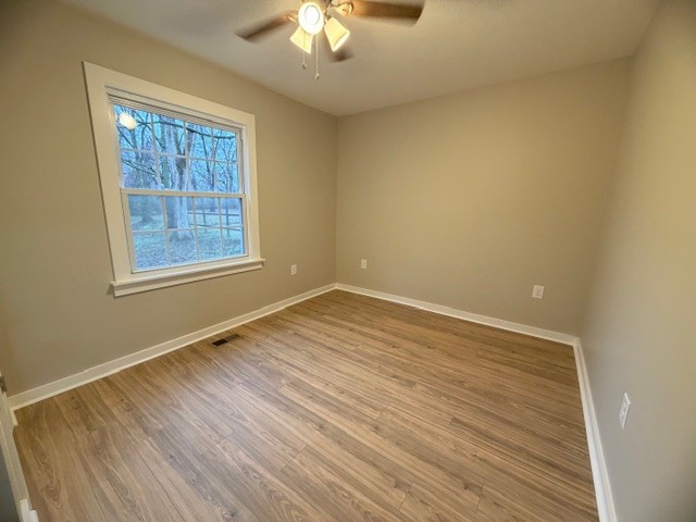 417 Laura Avenue Winchester, TN 37398 - Photo 14 of 18 a view of an empty room with wooden floor and a window