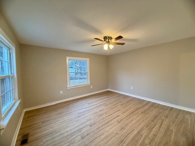 417 Laura Avenue Winchester, TN 37398 - Photo 4 of 18 a view of an empty room with a window and wooden floor