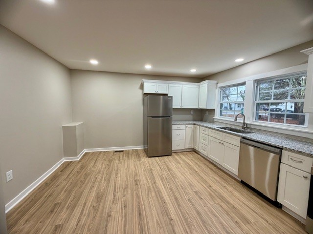 417 Laura Avenue Winchester, TN 37398 - Photo 7 of 18 a kitchen with stainless steel appliances granite countertop a refrigerator sink and wooden cabinets