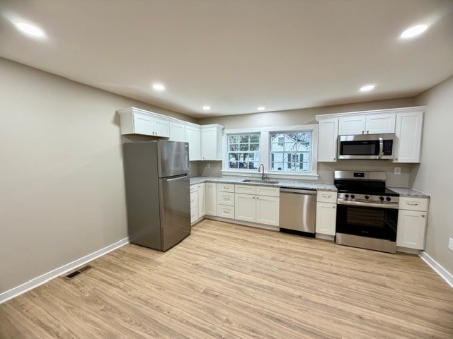 417 Laura Avenue Winchester, TN 37398 - Photo 8 of 18 a kitchen with stainless steel appliances granite countertop a refrigerator a stove top oven a sink dishwasher and a refrigerator with wooden floor