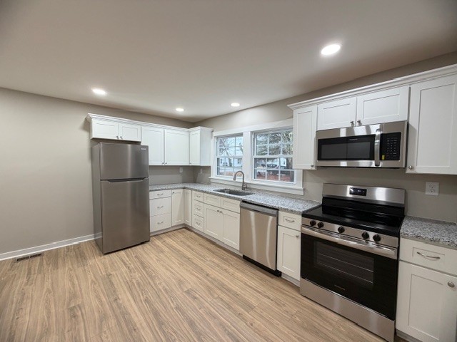 417 Laura Avenue Winchester, TN 37398 - Photo 9 of 18 a kitchen with granite countertop a refrigerator stove top oven and sink