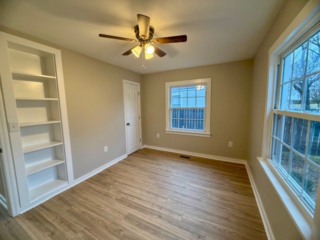417 Laura Avenue Winchester, TN 37398 - Photo 10 of 18 a view of an empty room with a window and wooden floor