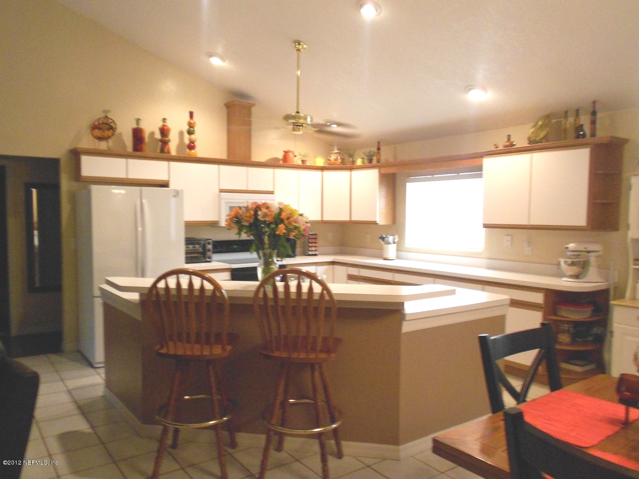 2796 Kings Road St. Augustine, FL 32086 - Photo 3 of 20 a kitchen with stainless steel appliances kitchen island granite countertop a table chairs in it and a window