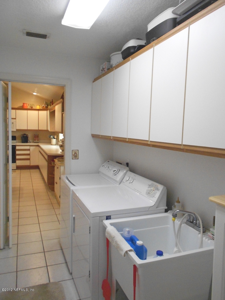2796 Kings Road St. Augustine, FL 32086 - Photo 8 of 20 a view of a kitchen with furniture and large windows