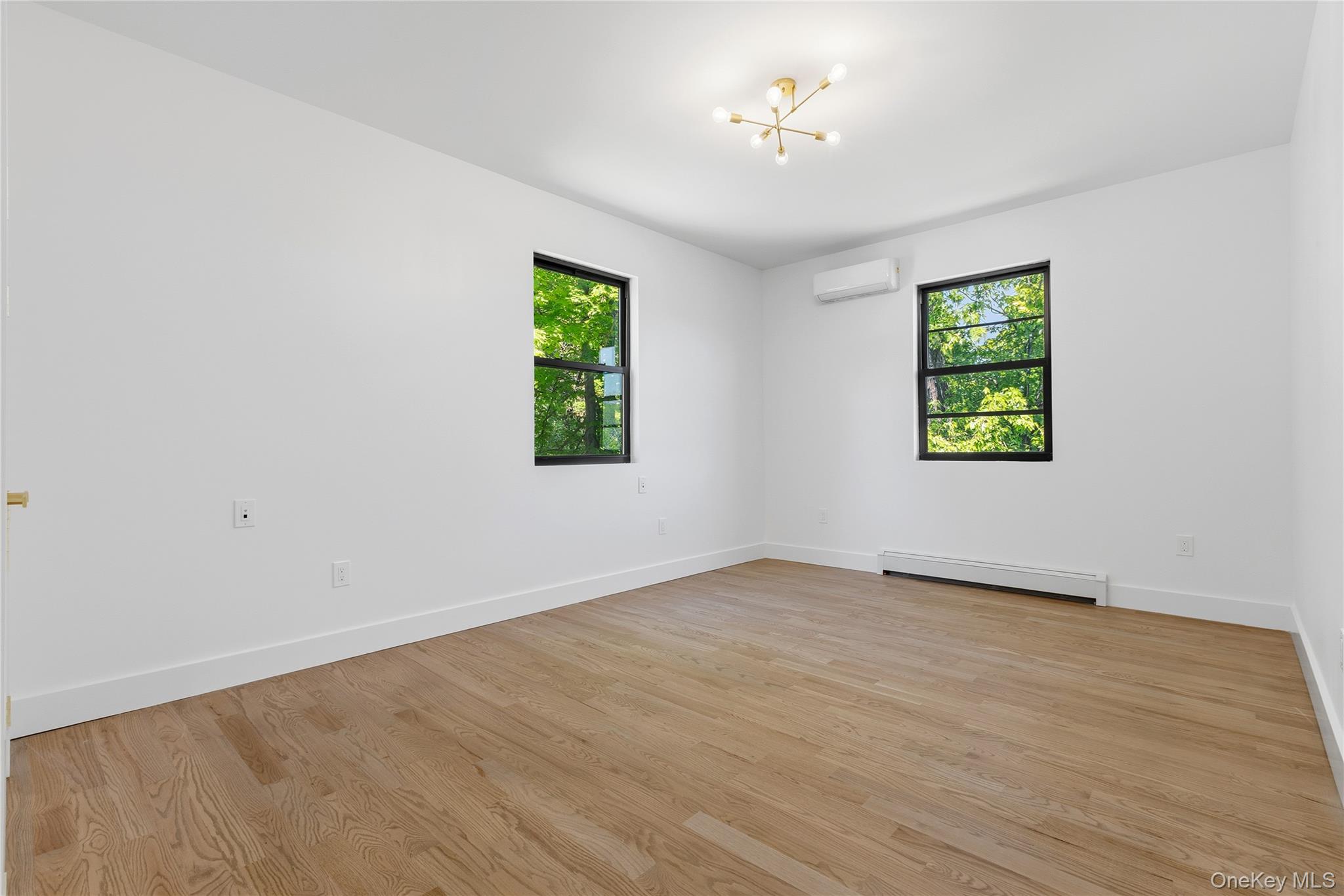 548 Lakes Road Monroe, NY 10950 - Photo 38 of 50 wooden floor in an empty room with a window