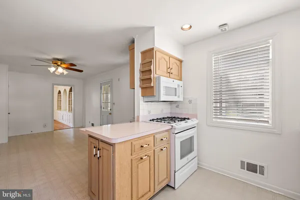 a kitchen with a stove a sink and a window
