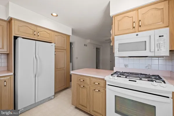 a kitchen with cabinets appliances and a counter space