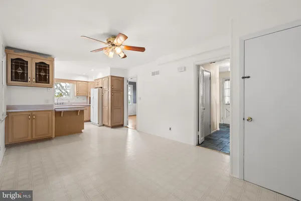 a view of a kitchen with a sink and a refrigerator