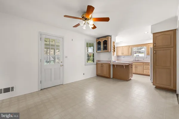 a view of a kitchen with a sink dishwasher a refrigerator and cabinets