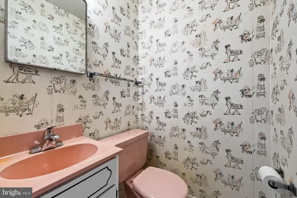 a bathroom with a sink toilet and a mirror
