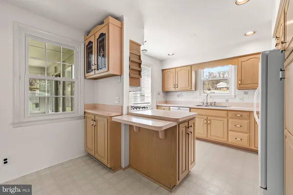 a kitchen that has a sink and a stove in it
