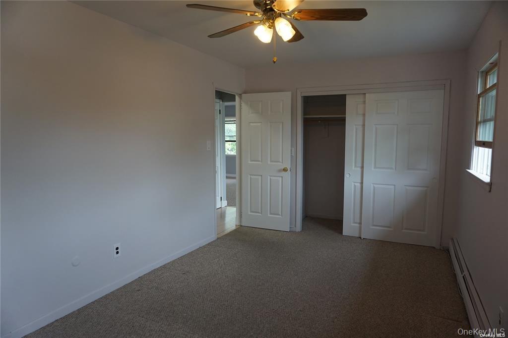 15 Reed Drive Deer Park, NY 11729 - Photo 11 of 12 an empty room with chandelier fan