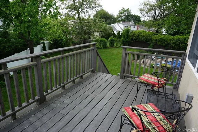 a view of balcony with wooden floor and outdoor seating