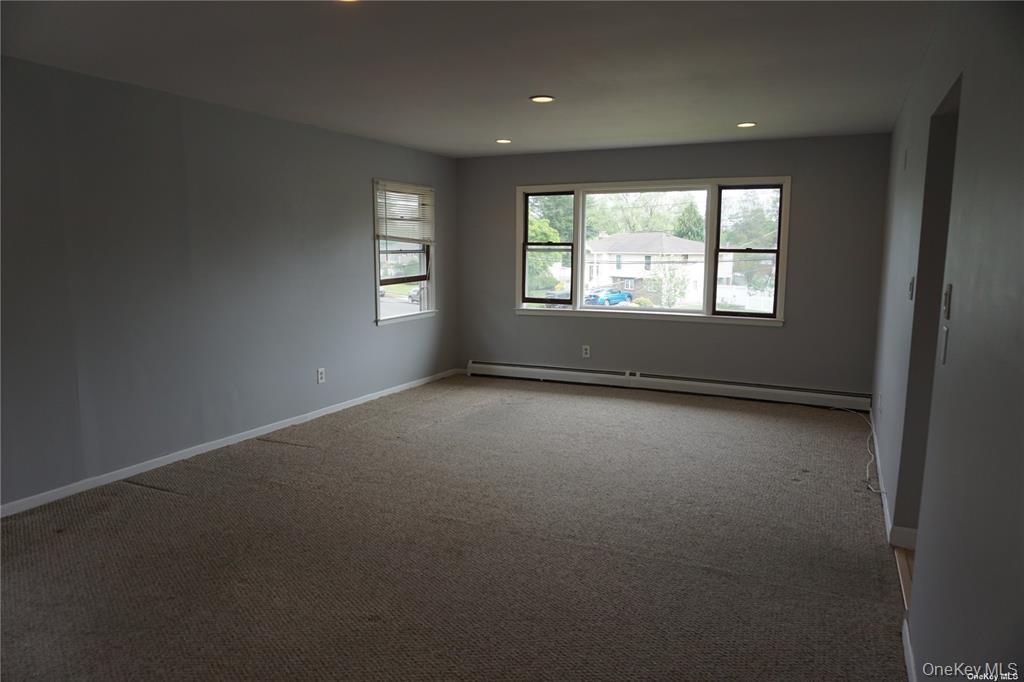 15 Reed Drive Deer Park, NY 11729 - Photo 4 of 12 an empty room with a window