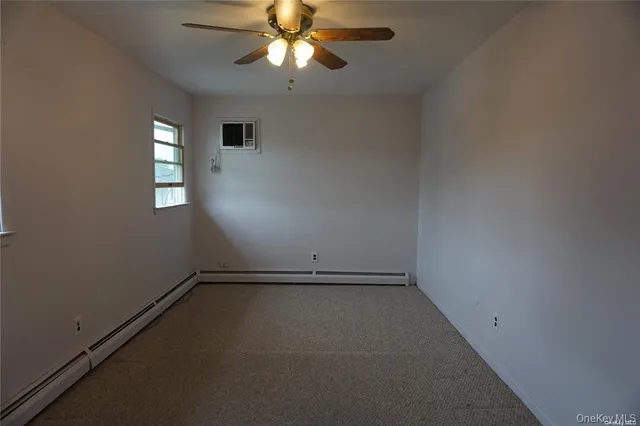 an empty room with chandelier fan