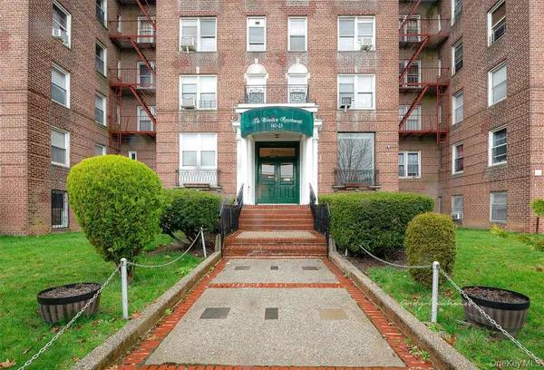 a view of a brick building next to a yard