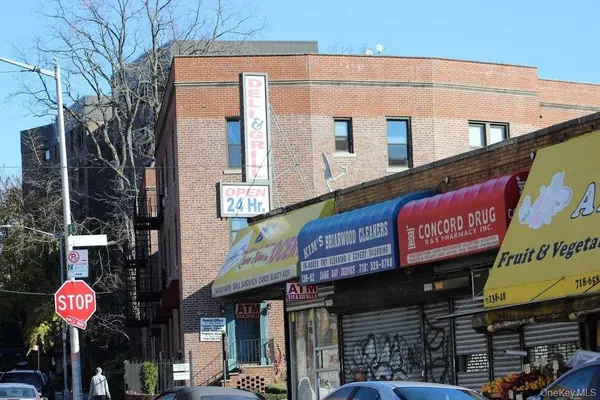 a front view of multi story building with retail shops