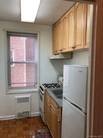 a kitchen with a stove and a window