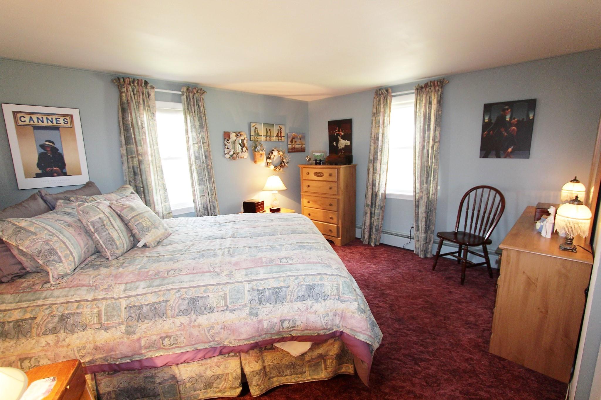 35 Tuckernuck Road Centerville, MA 02632 - Photo 11 of 28 a spacious bedroom with a bed and a dresser in it