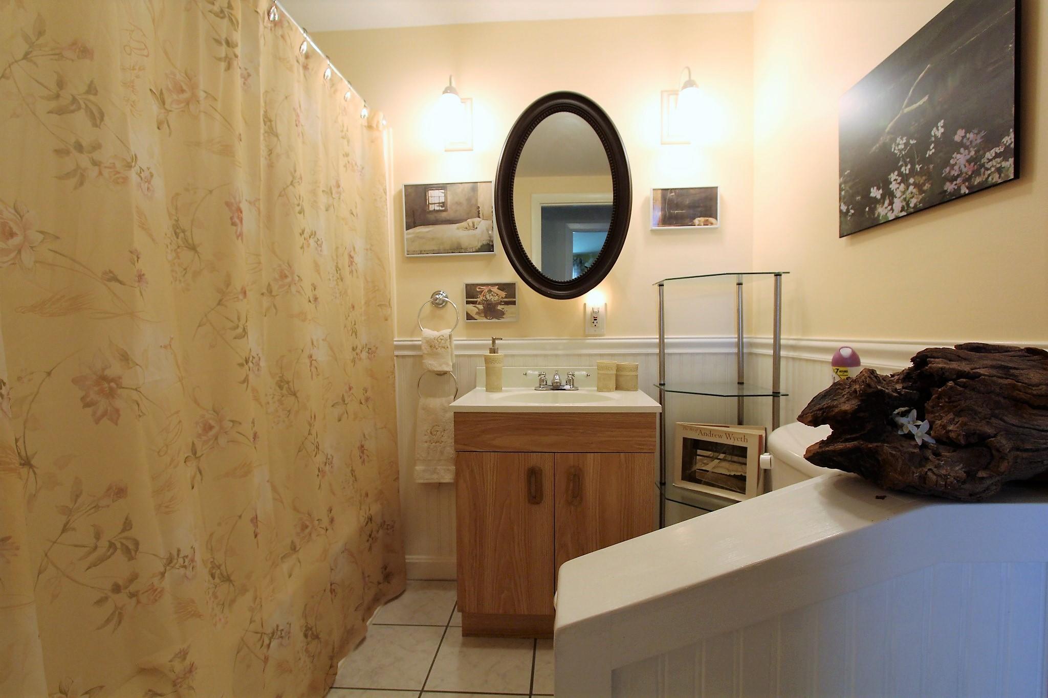 35 Tuckernuck Road Centerville, MA 02632 - Photo 14 of 28 a bathroom with a sink a mirror and a toilet