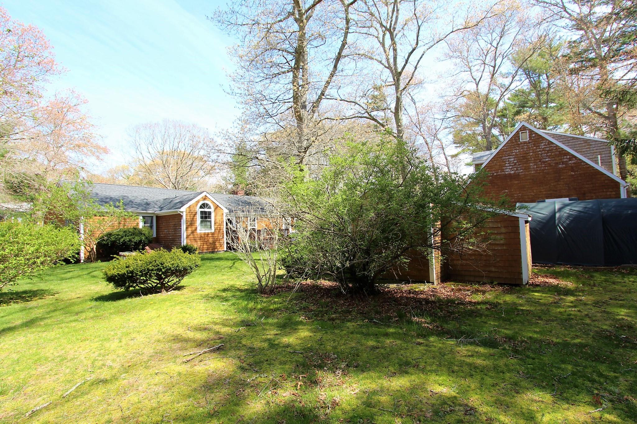 35 Tuckernuck Road Centerville, MA 02632 - Photo 19 of 28 a front view of a house with a yard and trees