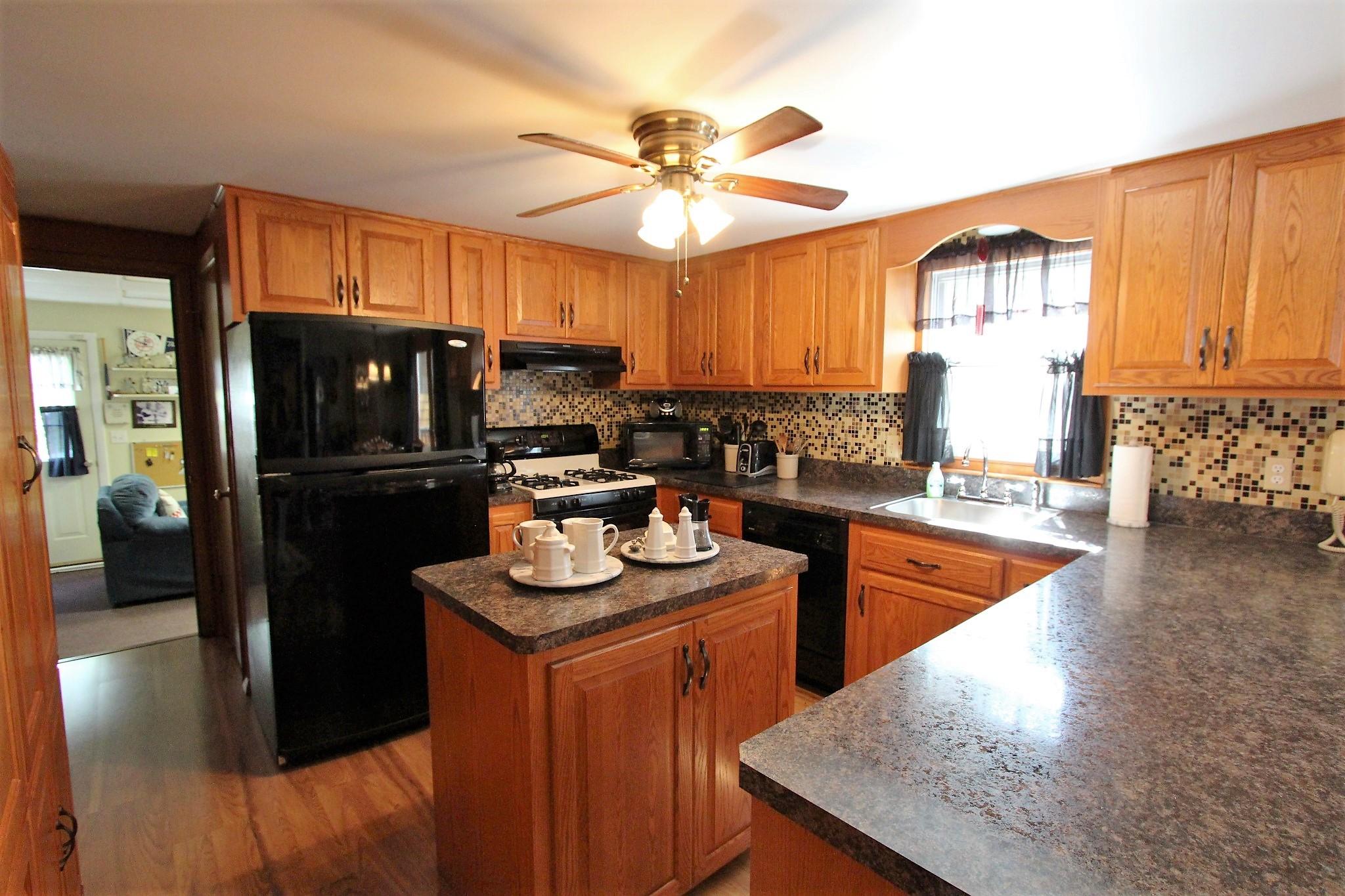 35 Tuckernuck Road Centerville, MA 02632 - Photo 20 of 28 a kitchen with stainless steel appliances granite countertop a sink stove and refrigerator