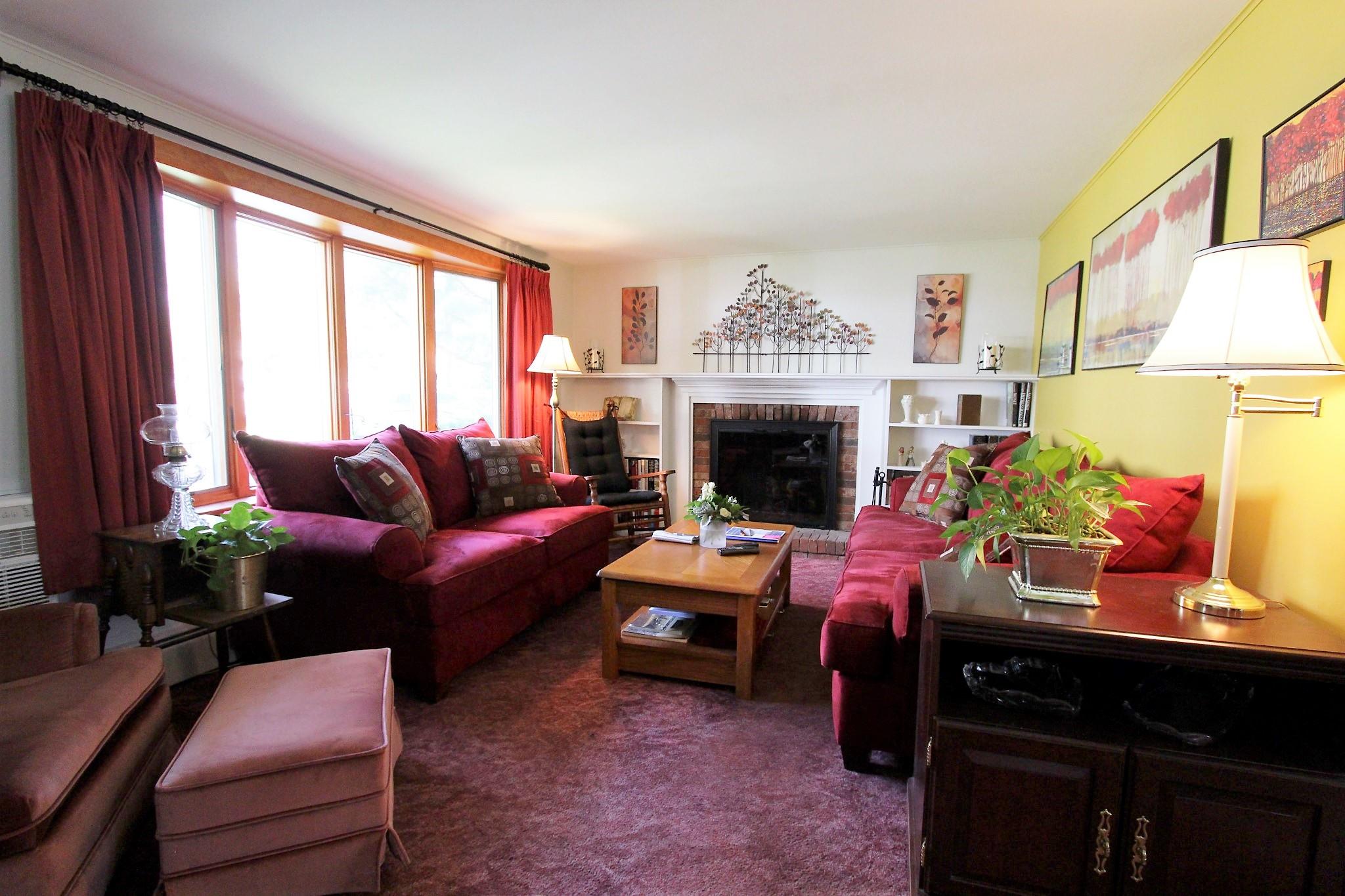 35 Tuckernuck Road Centerville, MA 02632 - Photo 28 of 28 a living room with furniture a fireplace and a floor to ceiling window