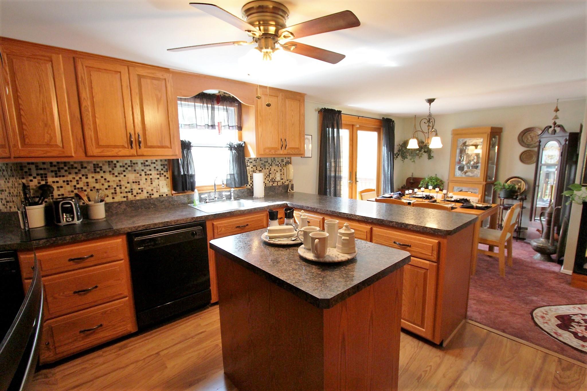 35 Tuckernuck Road Centerville, MA 02632 - Photo 4 of 28 a kitchen with a sink stove and cabinets
