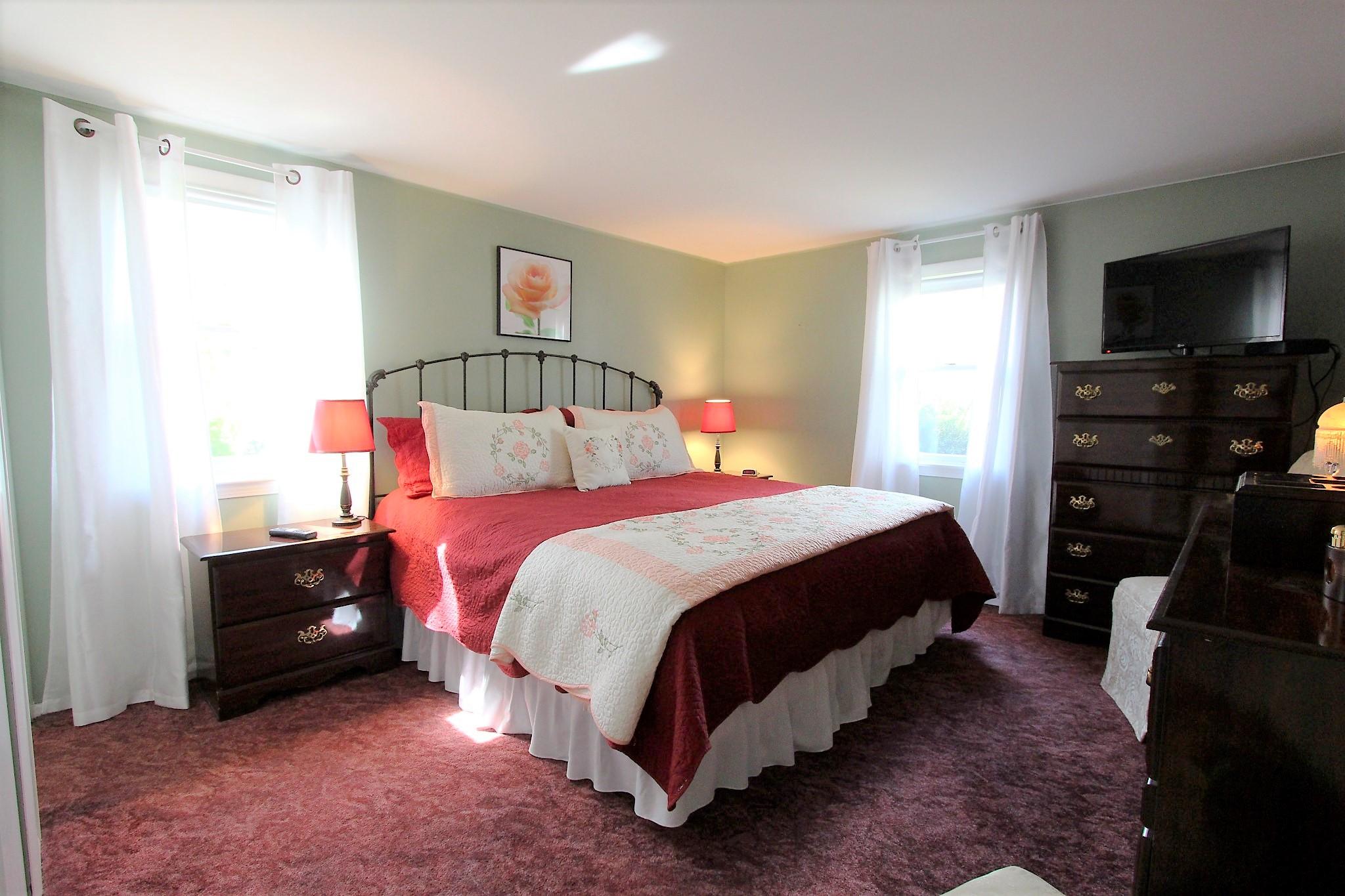 35 Tuckernuck Road Centerville, MA 02632 - Photo 6 of 28 a bedroom with a bed and a flat tv screen on the dresser