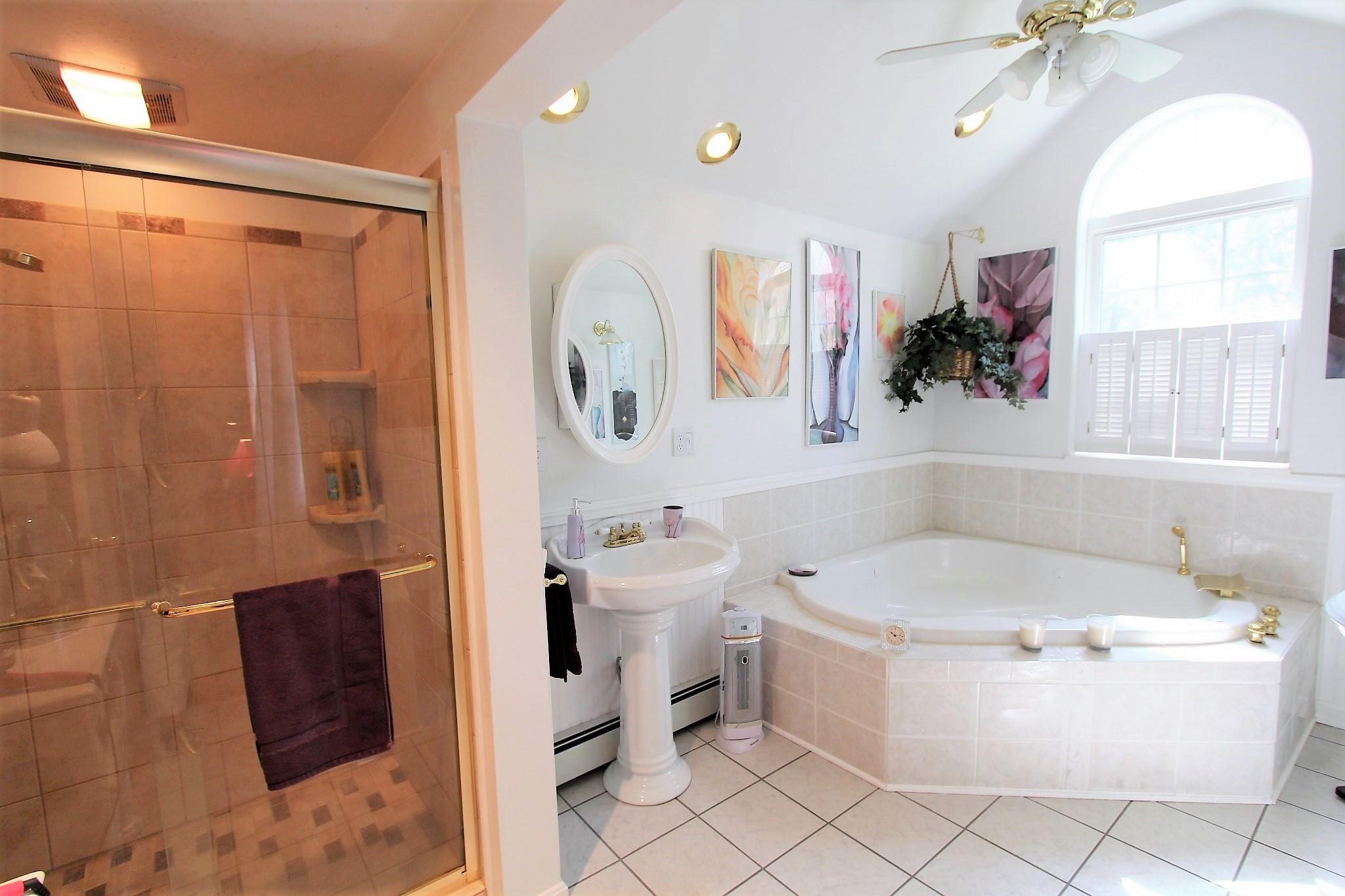 35 Tuckernuck Road Centerville, MA 02632 - Photo 7 of 28 a bathroom with a sink mirror vanity and toilet