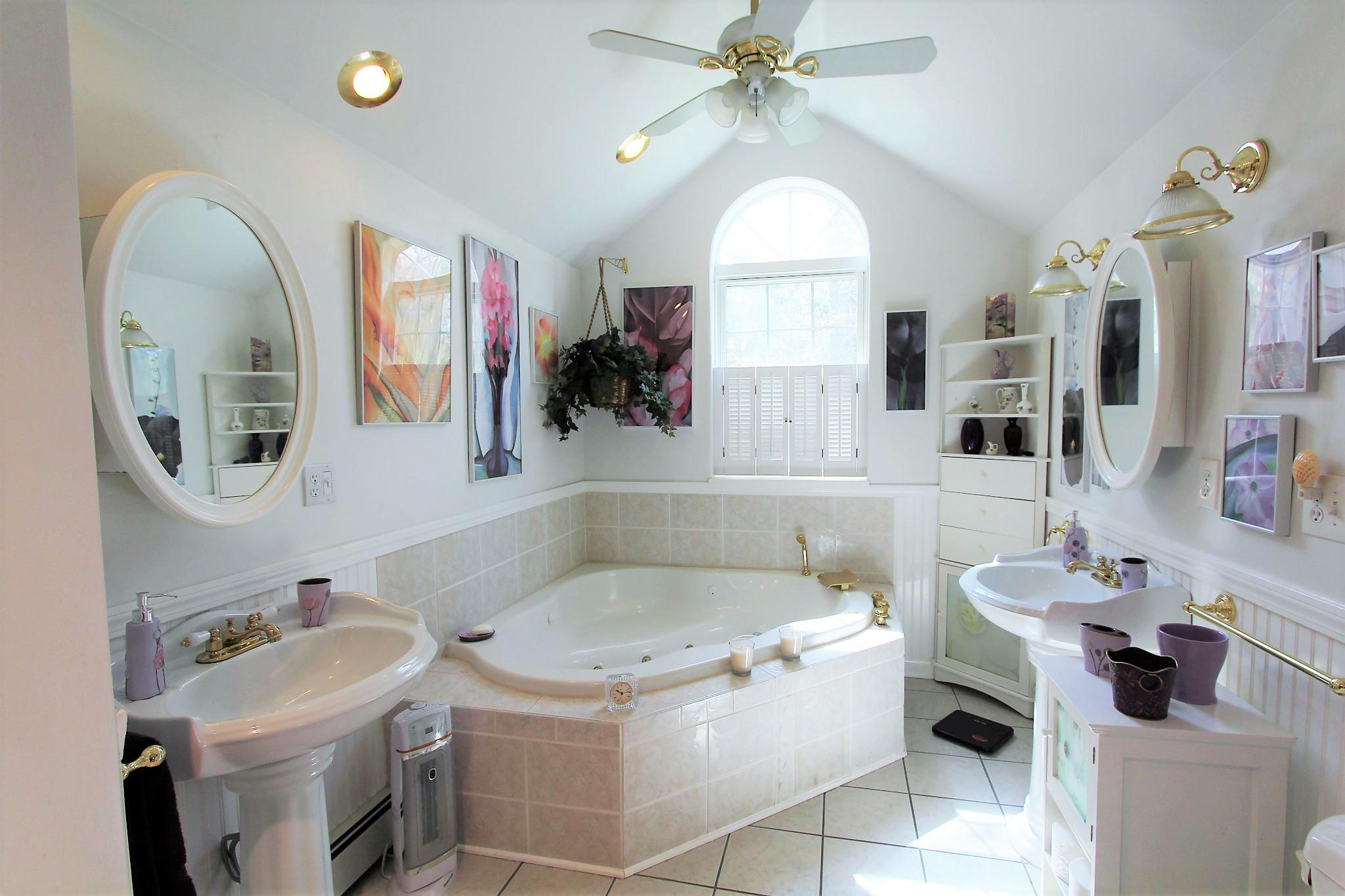 35 Tuckernuck Road Centerville, MA 02632 - Photo 8 of 28 a bathroom with a sink a vanity and mirror