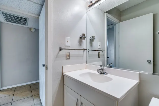 a view of a patio with a table and chairs under an umbrella