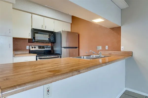 a kitchen with a stove microwave and sink