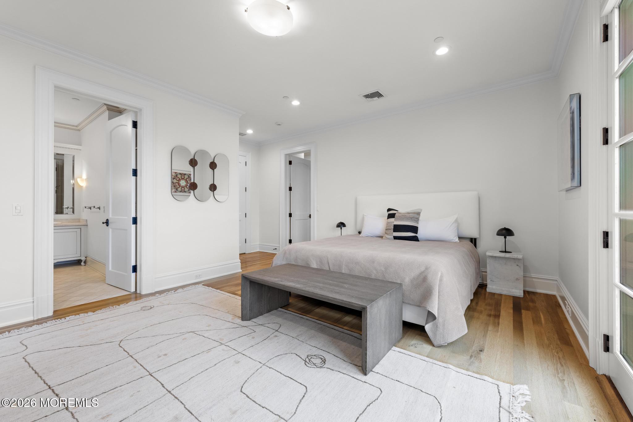 88 Montrose Road Colts Neck, NJ 07722 - Photo 38 of 73 a spacious bedroom with a bed and a wooden floor