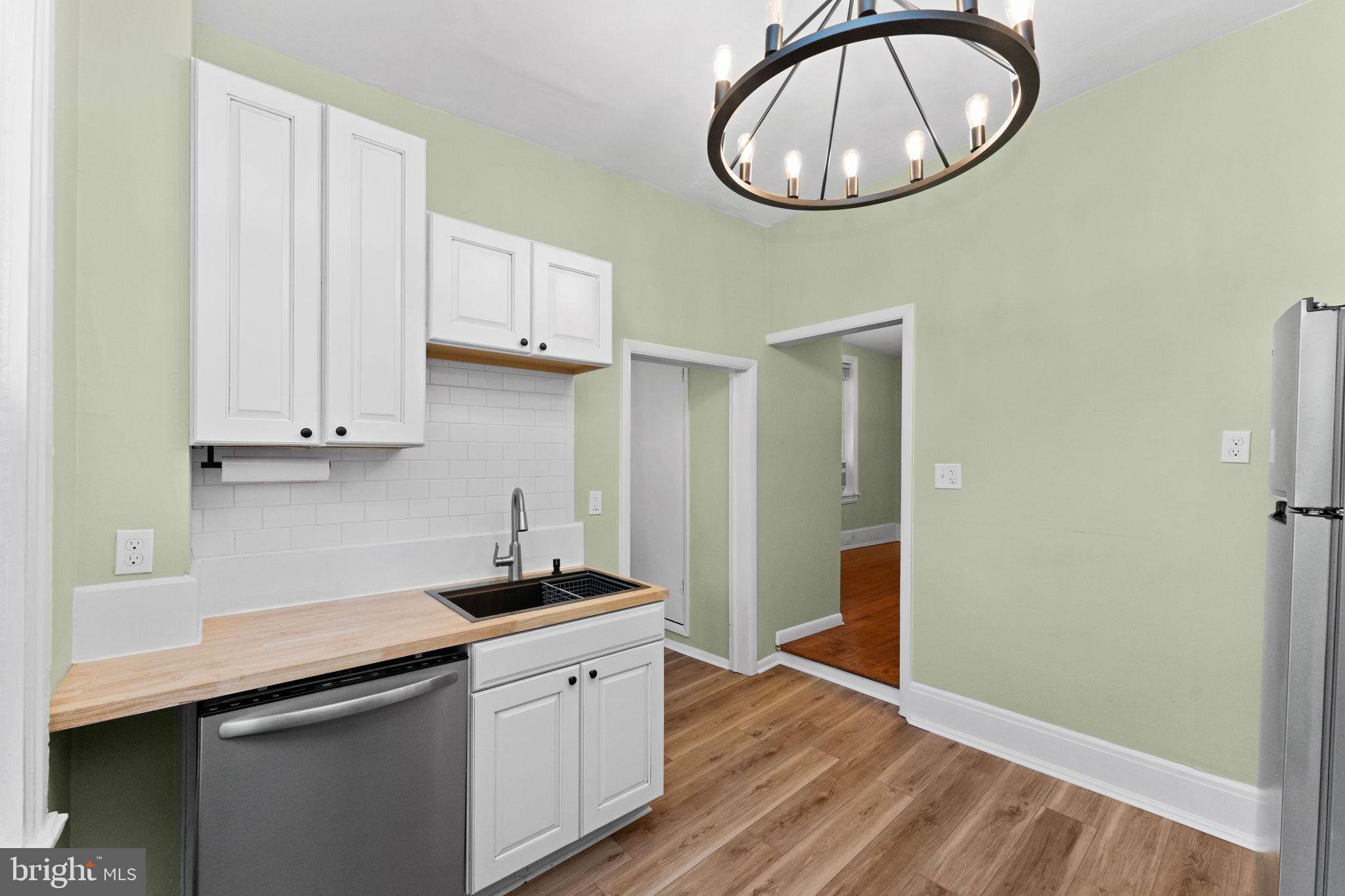 345 Hall Street Phoenixville, PA 19460 - Photo 13 of 32 a kitchen with a sink cabinets and a wooden floor
