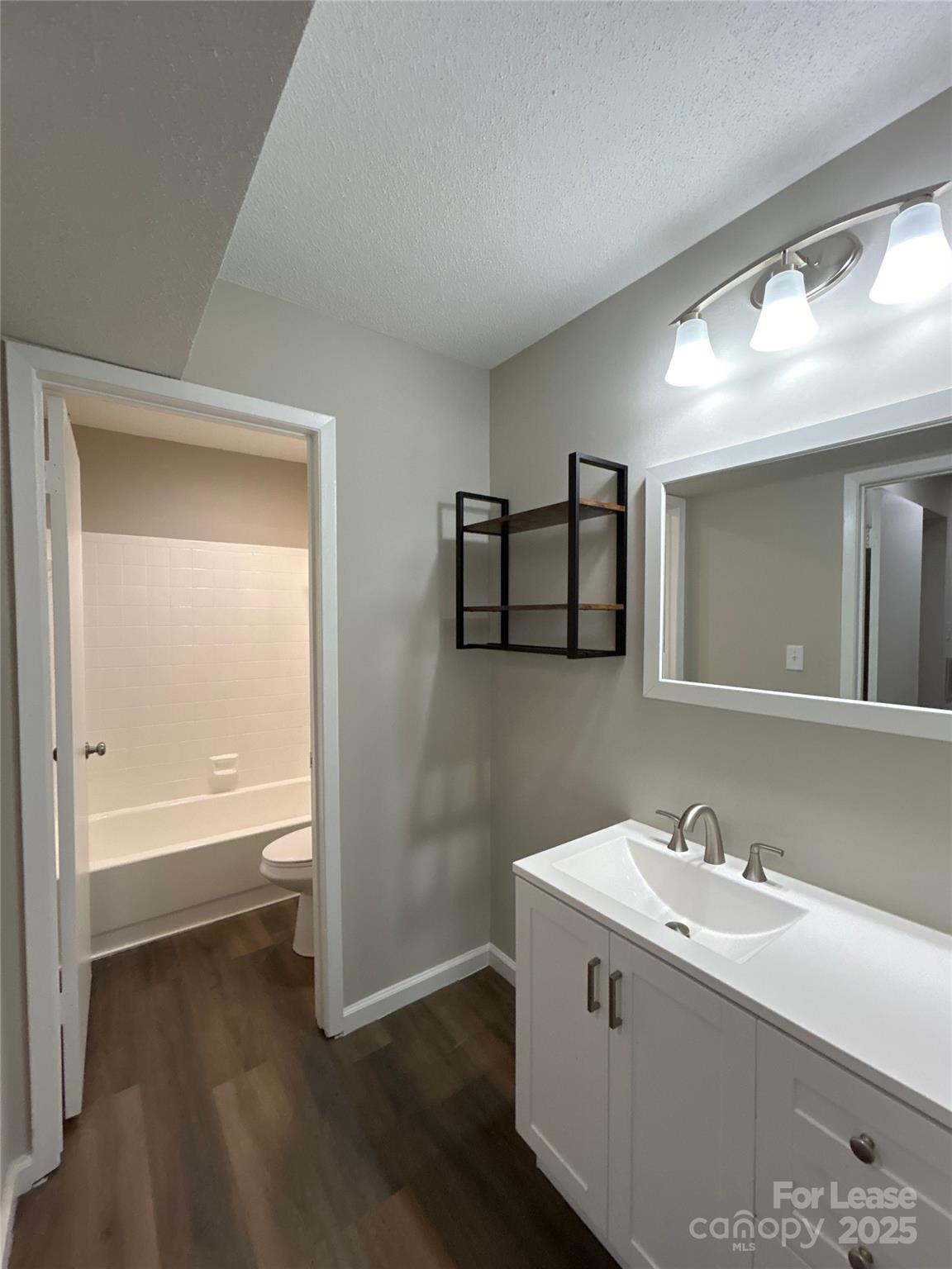 5008 Sardis Road, Unit F Charlotte, NC 28270 - Photo 15 of 19 a bathroom with a bathtub a sink and a mirror