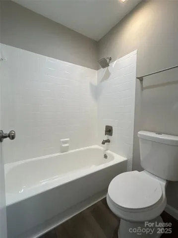 a bathroom with a toilet and a bathtub
