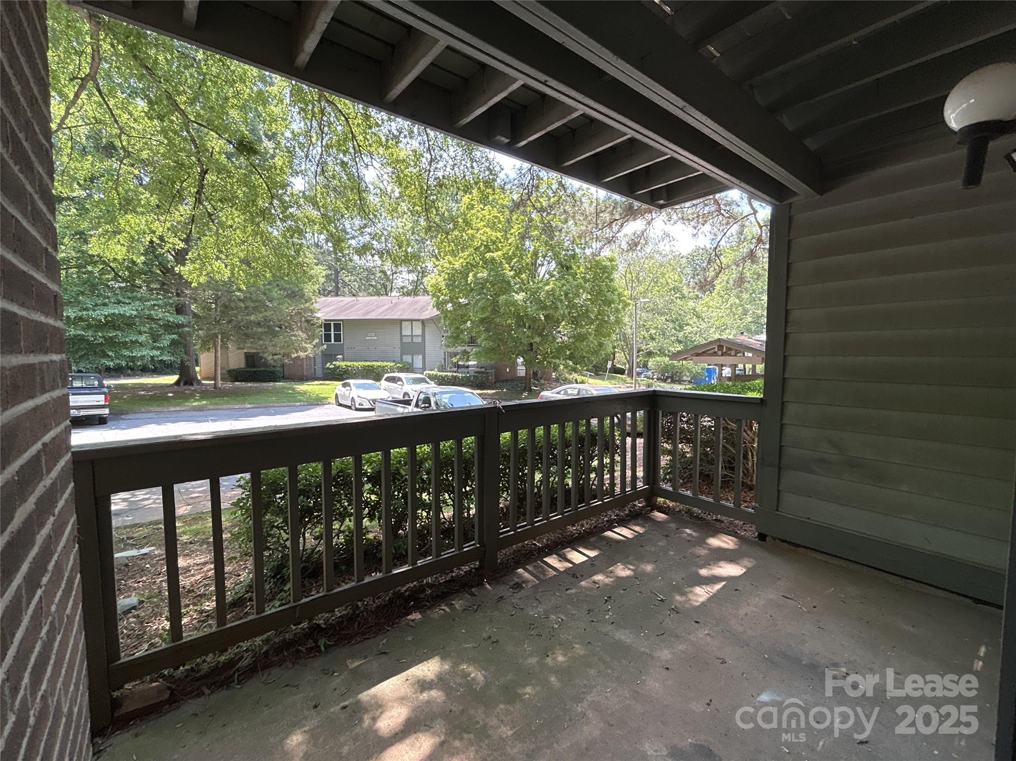 5008 Sardis Road, Unit F Charlotte, NC 28270 - Photo 17 of 19 a balcony with wooden floor in outdoor space