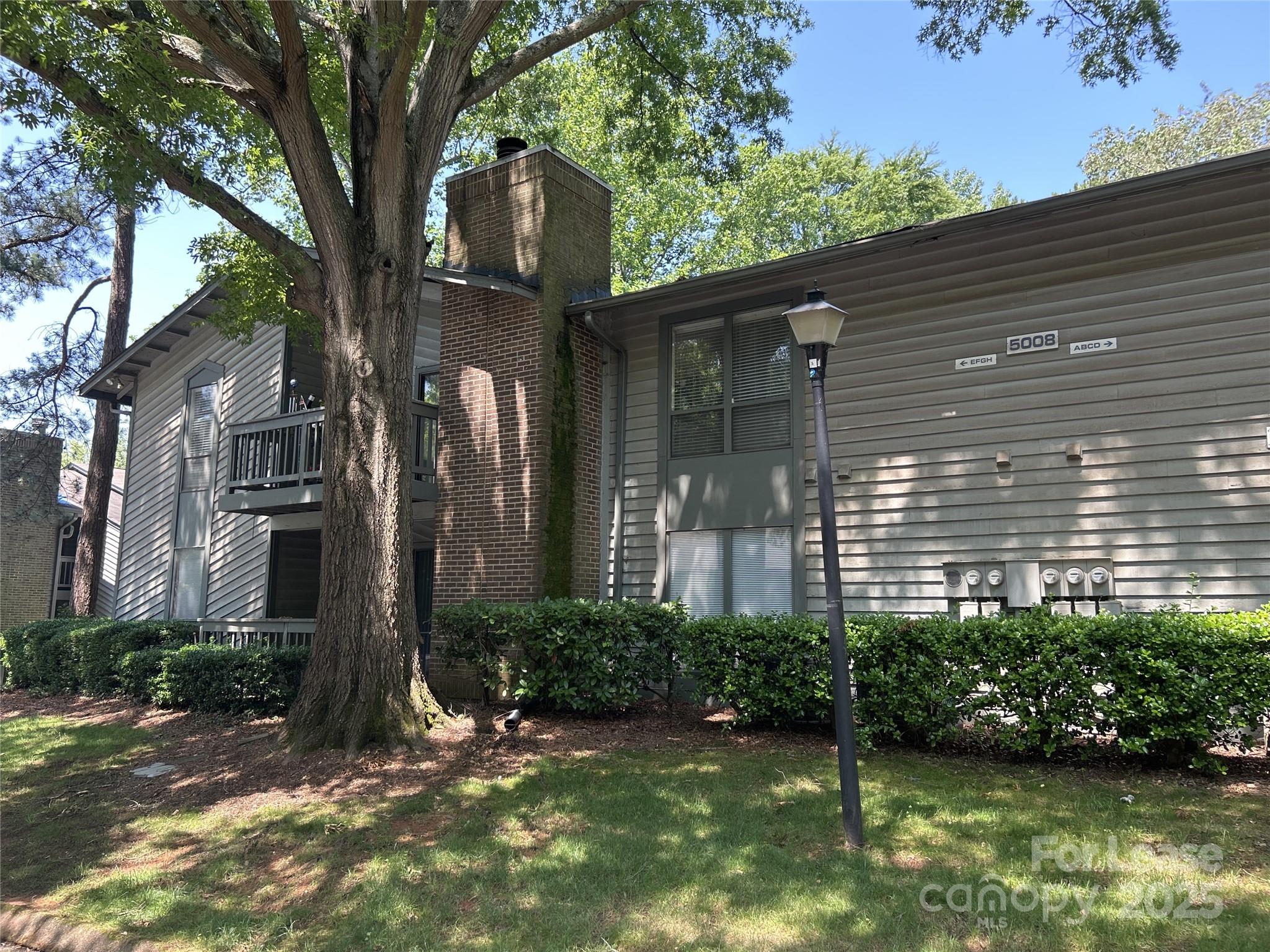 5008 Sardis Road, Unit F Charlotte, NC 28270 - Photo 3 of 19 a front view of a house with garden
