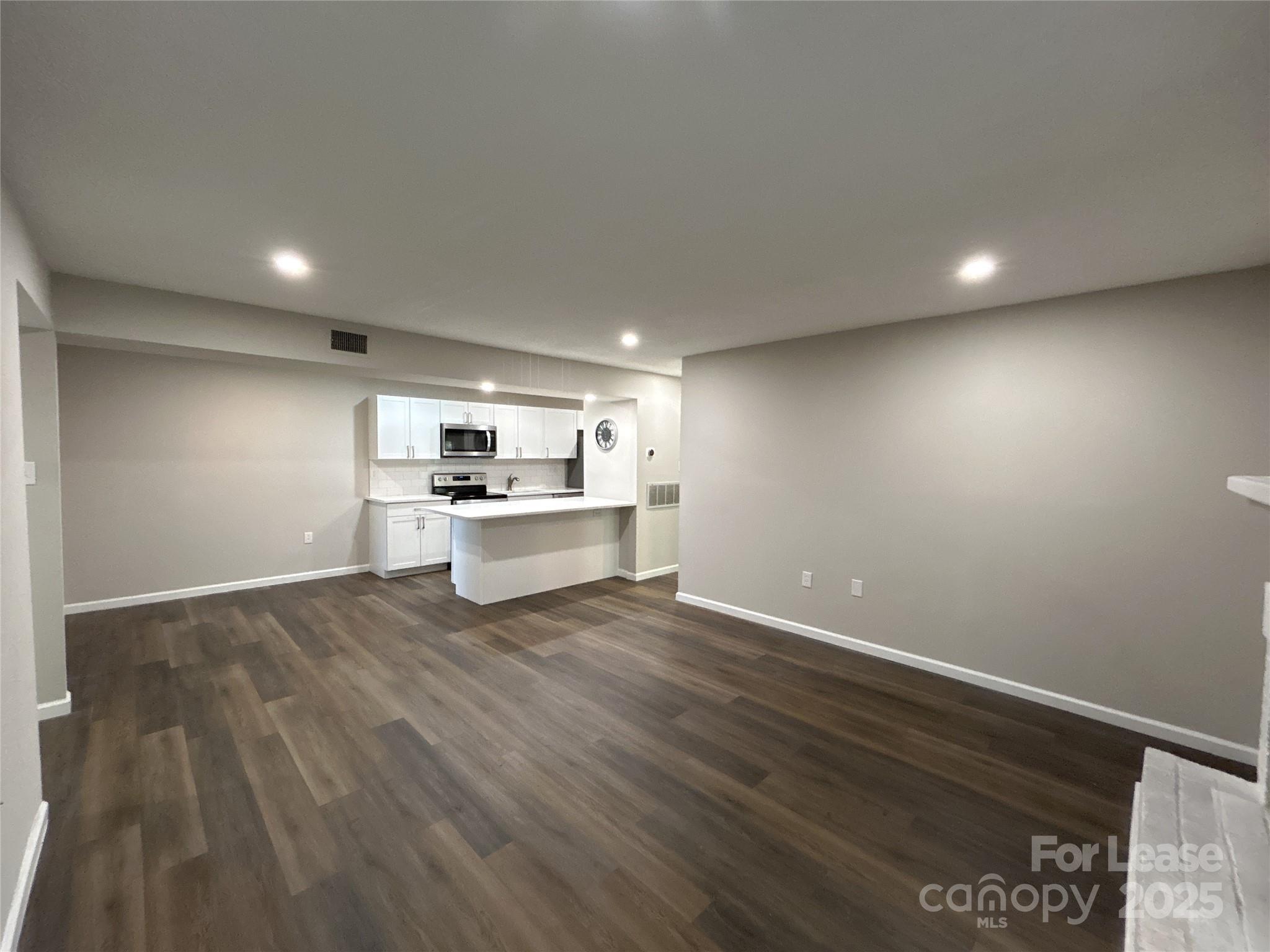 5008 Sardis Road, Unit F Charlotte, NC 28270 - Photo 6 of 19 a view of kitchen with wooden floor