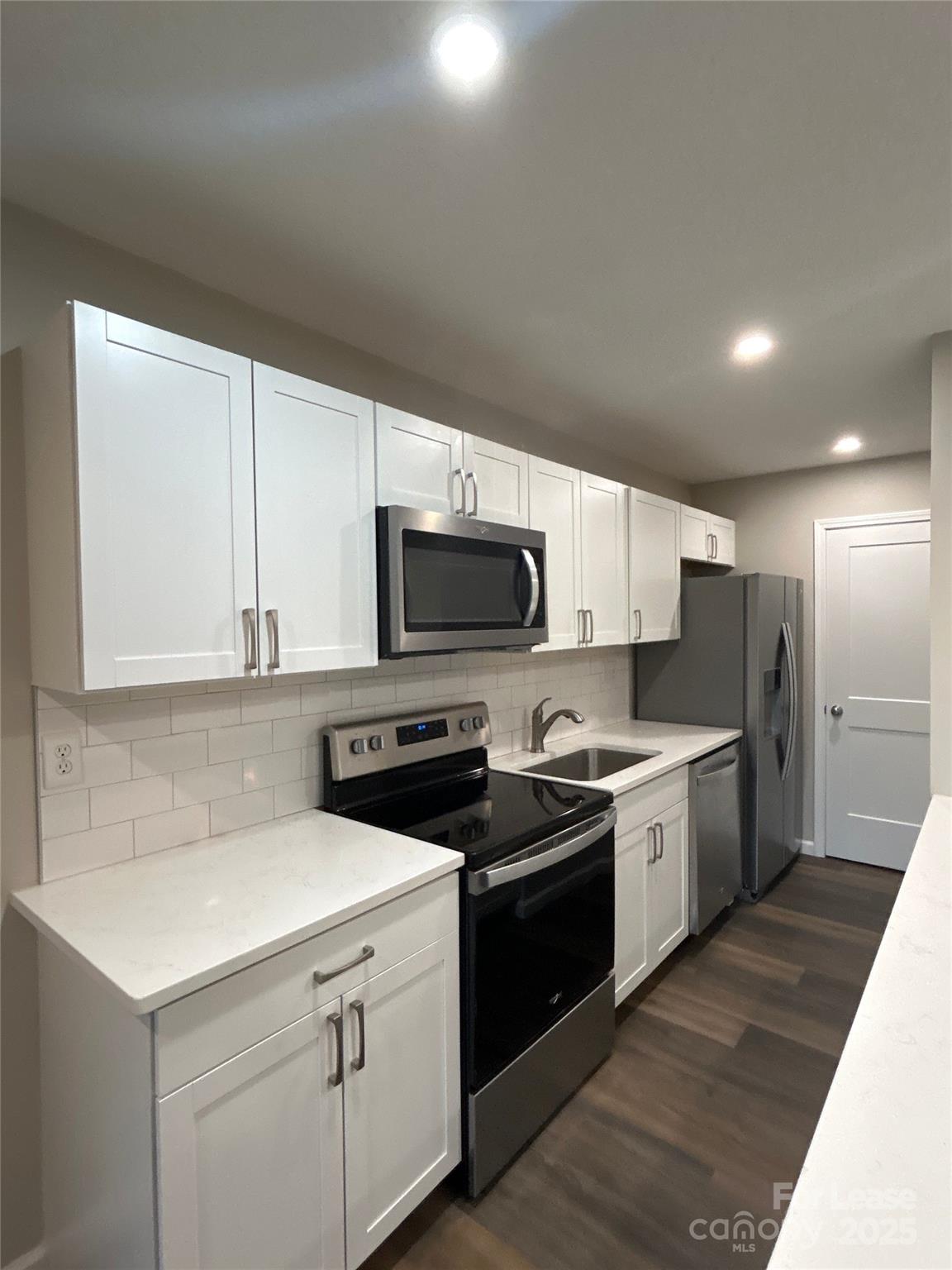 5008 Sardis Road, Unit F Charlotte, NC 28270 - Photo 10 of 19 a kitchen with stainless steel appliances a stove a sink dishwasher a refrigerator and a microwave