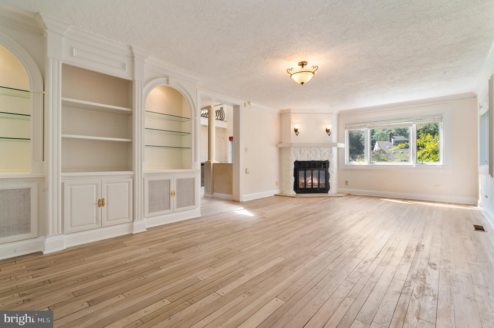 15729 Holly Grove Road Silver Spring, MD 20905 - Photo 29 of 83 a view of a livingroom with wooden floor fireplace and window