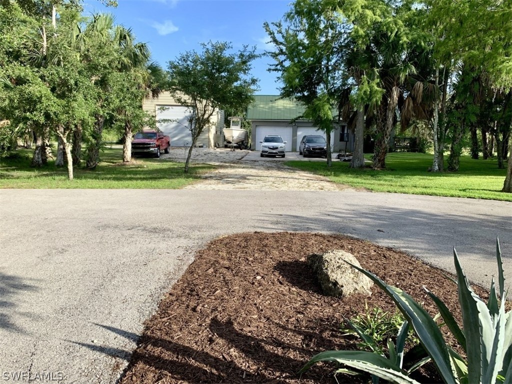 11120 Immokalee Road Naples, FL 34120 - Photo 3 of 12 a house with trees in front of it